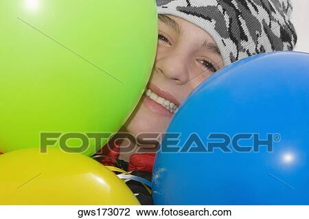 Portrait of a teenage boy smiling with balloons View Large Photo Image Stock Image - Portrait of a teenage boy smiling with balloons. Fotosearch