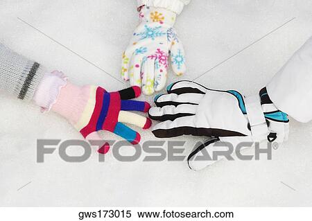 Stock Photography - Three people playing in snow. Fotosearch