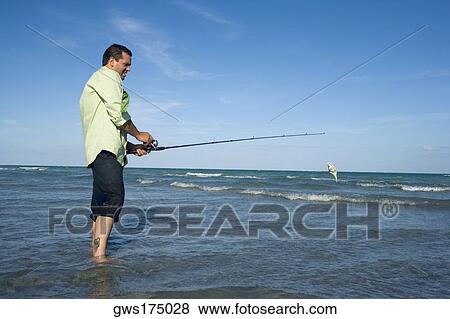 Side profile of a mid adult man fishing in the sea View Large Photo Image Stock Photo - Side profile of a mid adult man fishing in the sea. Fotosearch