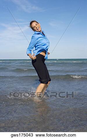 Side profile of a mid adult woman dancing on the beach View Large Photo Image Stock Image - Side profile of a mid adult woman dancing on the beach. Fotosearch