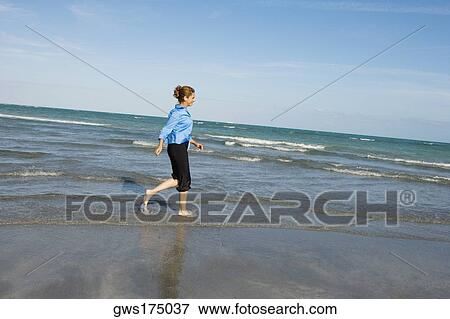 Side profile of a mid adult woman walking on the beach View Large Photo Image Stock Photo - Side profile of a mid adult woman walking on the beach. Fotosearch