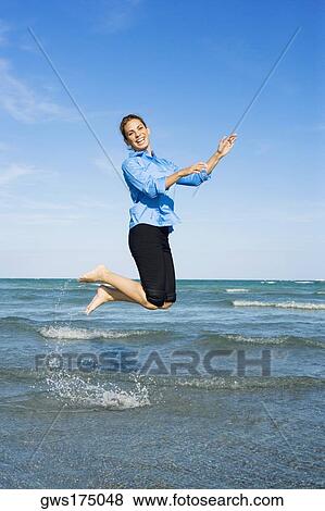 Side profile of a mid adult woman jumping on the beach View Large Photo Image Stock Photo - Side profile of a mid adult woman jumping on the beach. Fotosearch