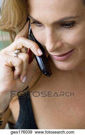 Close-up of a mature woman talking on a mobile phone View Large Photo Image Stock Photo - Close-up of a mature woman talking on a mobile phone. Fotosearch
