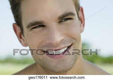 Stock Image - Close-up of a young man smiling. Fotosearch