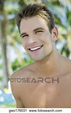 Close-up of a young man smiling View Large Photo Image Stock Image - Close-up of a young man smiling. Fotosearch