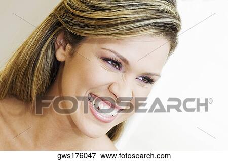 Close-up of a young woman smiling View Large Photo Image Stock Photo - Close-up of a young woman smiling. Fotosearch