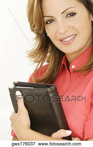 Portrait of a businesswoman holding a personal organizer View Large Photo Image Stock Photo - Portrait of a businesswoman holding a personal organizer. Fotosearch