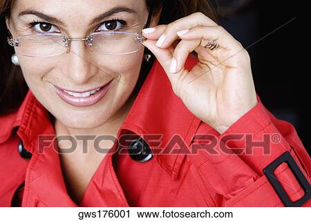 Portrait of a mature woman wearing eyeglasses and smiling View Large Photo Image Stock Image - Portrait of a mature woman wearing eyeglasses and smiling. Fotosearch