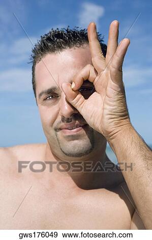 Portrait of a mid adult man making an OK sign View Large Photo Image Stock Photo - Portrait of a mid adult man making an OK sign. Fotosearch