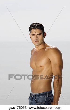 Portrait of a mid adult man standing on the beach View Large Photo Image Stock Image - Portrait of a mid adult man standing on the beach. Fotosearch