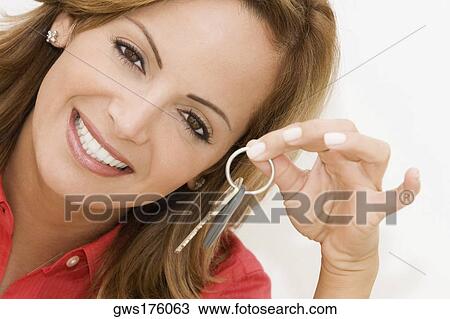 Portrait of a mid adult woman showing a car key View Large Photo Image Stock Image - Portrait of a mid adult woman showing a car key. Fotosearch