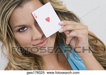 Portrait of a young woman holding an ace card and smiling View Large Photo Image Stock Photography - Portrait of a young woman holding an ace card and smiling. Fotosearch