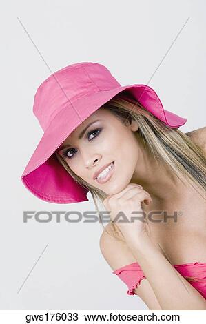 Portrait of a young woman smiling with her hands on her chin View Large Photo Image Stock Image - Portrait of a young woman smiling with her hands on her chin. Fotosearch