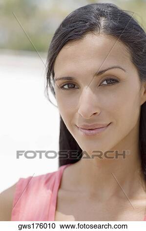Portrait of a young woman smirking View Large Photo Image Stock Image - Portrait of a young woman smirking. Fotosearch