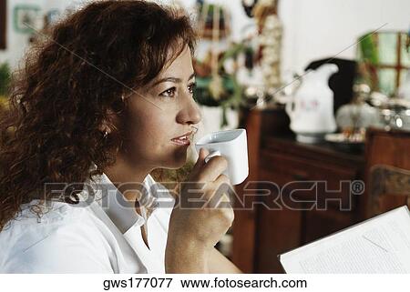 Stock Photo - Close-up of a mature woman drinking a cup of tea. Fotosearch