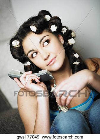 Close-up of a teenage girl holding a telephone View Large Photo Image Stock Photo - Close-up of a teenage girl holding a telephone. Fotosearch