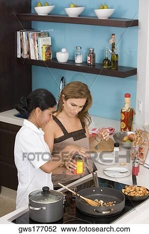 High angle view of a mature woman and her maid preparing food in the kitchen View Large Photo Image Stock Image - High angle view of a mature woman and her maid preparing food in the kitchen. Fotosearch
