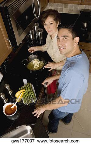 High angle view of a mid adult man with his mother in the kitchen View Large Photo Image Stock Photo - High angle view of a mid adult man with his mother in the kitchen. Fotosearch