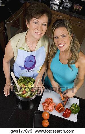 High angle view of a young woman preparing food with her mother in the kitchen View Large Photo Image Stock Image - High angle view of a young woman preparing food with her mother in the kitchen. Fotosearch