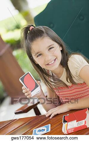 Portrait of a girl showing playing cards and smiling View Large Photo Image Picture - Portrait of a girl showing playing cards and smiling. Fotosearch