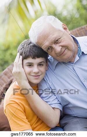 Stock Photography - Portrait of a senior man with his grandson grinning. Fotosearch