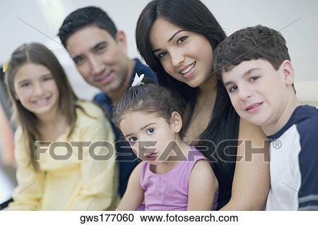 Portrait of three children sitting together with their parents View Large Photo Image Stock Image - Portrait of three children sitting together with their parents. Fotosearch