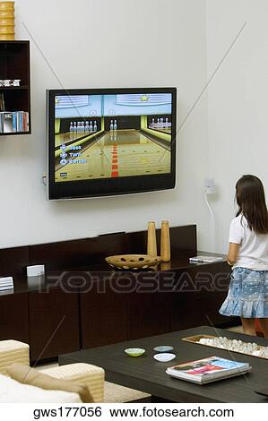Stock Photograph - Rear view of a girl watching television. Fotosearch