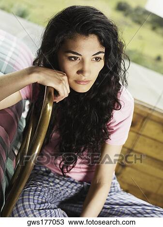 Young woman sitting on a chair and thinking View Large Photo Image Stock Image - Young woman sitting on a chair and thinking. Fotosearch