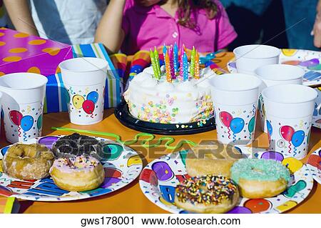 Birthday cake and donuts with presents on a table View Large Photo Image Stock Image - Birthday cake and donuts with presents on a table. Fotosearch