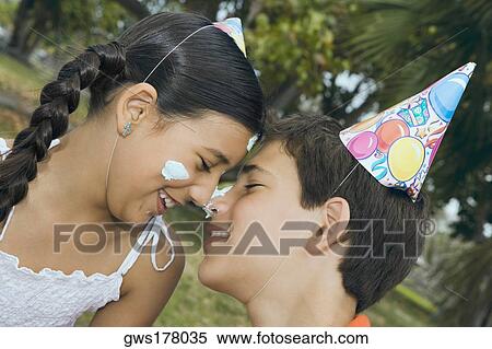 Close-up of a boy smiling with his sister View Large Photo Image Stock Photography - Close-up of a boy smiling with his sister. Fotosearch