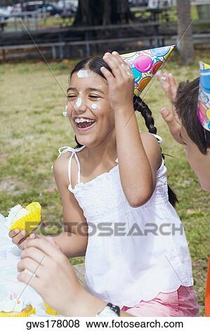 Stock Photo - Girl sitting with a boy and laughing. Fotosearch