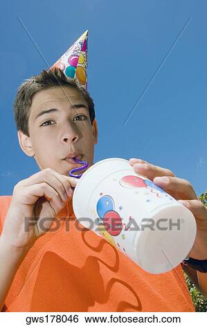 Low angle view of a boy drinking with a drinking straw View Large Photo Image Stock Photograph - Low angle view of a boy drinking with a drinking straw. Fotosearch