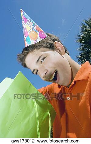 Portrait of a boy with a gift bag View Large Photo Image Stock Image - Portrait of a boy with a gift bag. Fotosearch