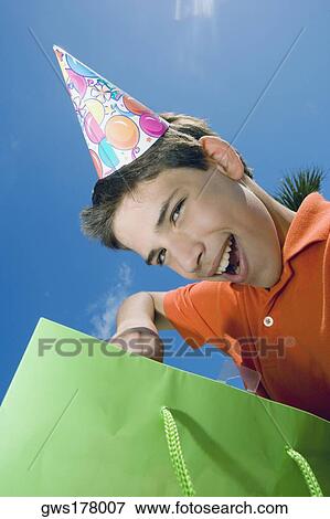 Portrait of a boy with a gift bag View Large Photo Image Stock Photo - Portrait of a boy with a gift bag. Fotosearch