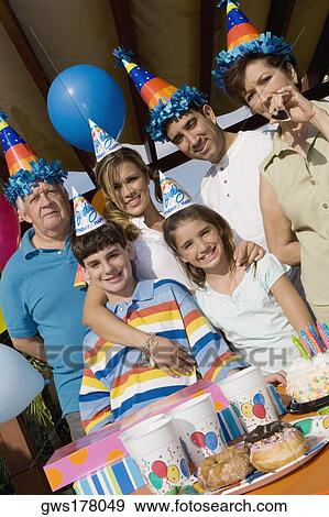 Portrait of a family celebrating a birthday party View Large Photo Image Stock Photo - Portrait of a family celebrating a birthday party. Fotosearch