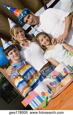 Portrait of a family celebrating a birthday party View Large Photo Image Stock Photography - Portrait of a family celebrating a birthday party. Fotosearch