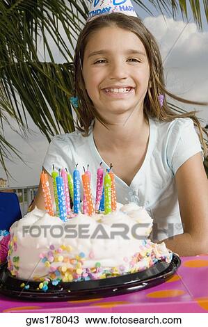 Portrait of a girl smiling in front of a birthday cake View Large Photo Image Stock Image - Portrait of a girl smiling in front of a birthday cake. Fotosearch