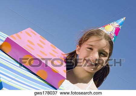 Portrait of a girl smiling with birthday presents View Large Photo Image Stock Photo - Portrait of a girl smiling with birthday presents. Fotosearch