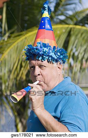Side profile of a senior man blowing a party horn blower View Large Photo Image Stock Image - Side profile of a senior man blowing a party horn blower. Fotosearch