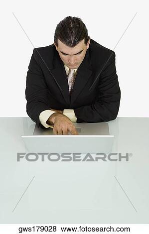 Businessman using a laptop View Large Photo Image Stock Photo - Businessman using a laptop. Fotosearch