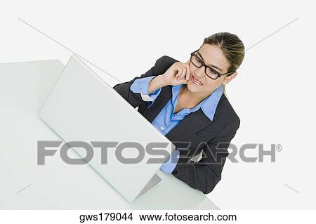 Picture - Businesswoman using a laptop. Fotosearch