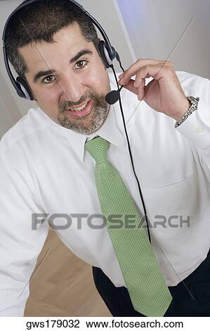 Portrait of a businessman wearing a headset View Large Photo Image Stock Image - Portrait of a businessman wearing a headset. Fotosearch