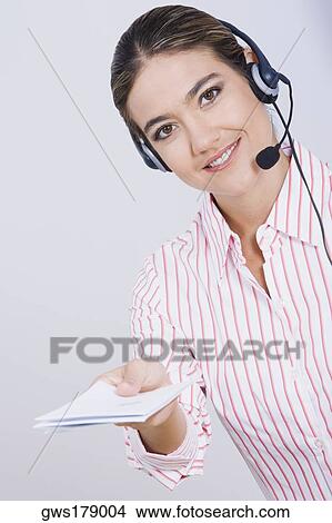 Portrait of a businesswoman holding documents and smiling View Large Photo Image Picture - Portrait of a businesswoman holding documents and smiling. Fotosearch