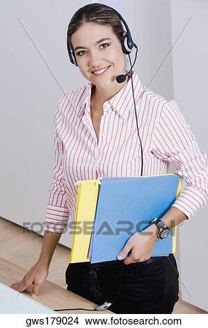 Portrait of a businesswoman holding files View Large Photo Image Picture - Portrait of a businesswoman holding files. Fotosearch