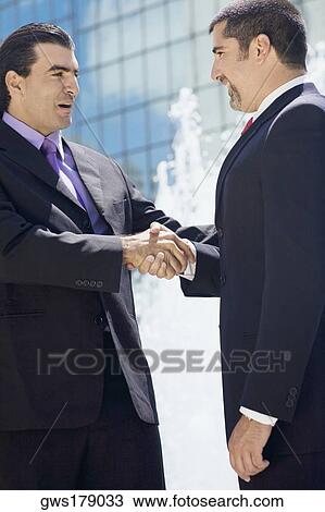 Side profile of two businessmen shaking hands View Large Photo Image Stock Image - Side profile of two businessmen shaking hands. Fotosearch