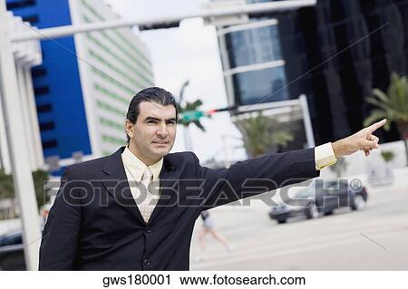 Businessman hailing a vehicle View Large Photo Image Stock Image - Businessman hailing a vehicle. Fotosearch