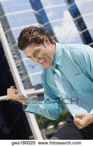Businessman making fists in excitement View Large Photo Image Stock Image - Businessman making fists in excitement. Fotosearch