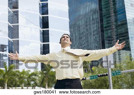 Businessman standing with his arms outstretched View Large Photo Image Stock Image - Businessman standing with his arms outstretched . Fotosearch