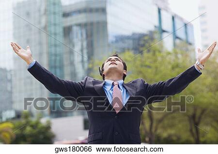 Businessman standing with his arms outstretched View Large Photo Image Stock Photograph - Businessman standing with his arms outstretched. Fotosearch