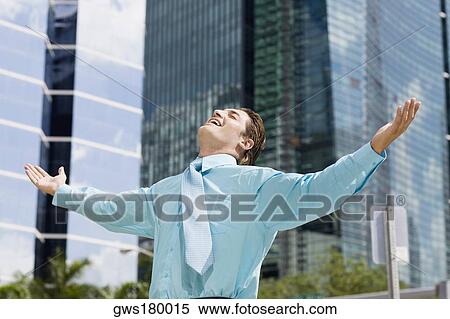 Stock Photography - Businessman standing with his arms outstretched . Fotosearch